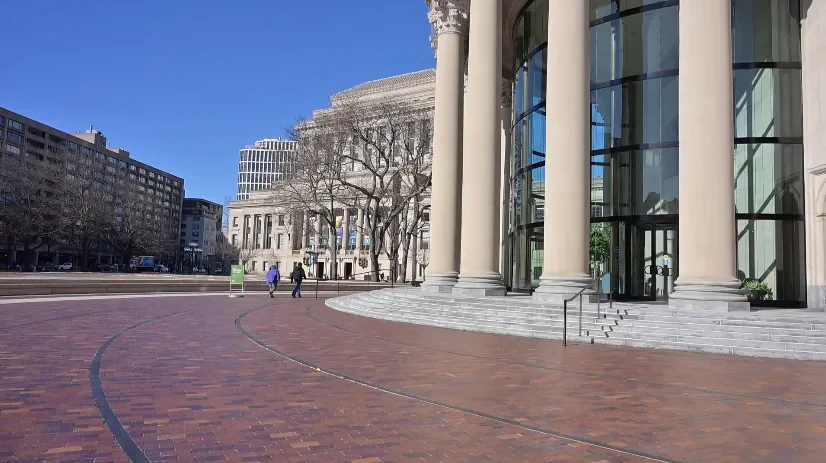 City plaza with columns and buildings, filmed as a background plate for the city scenes