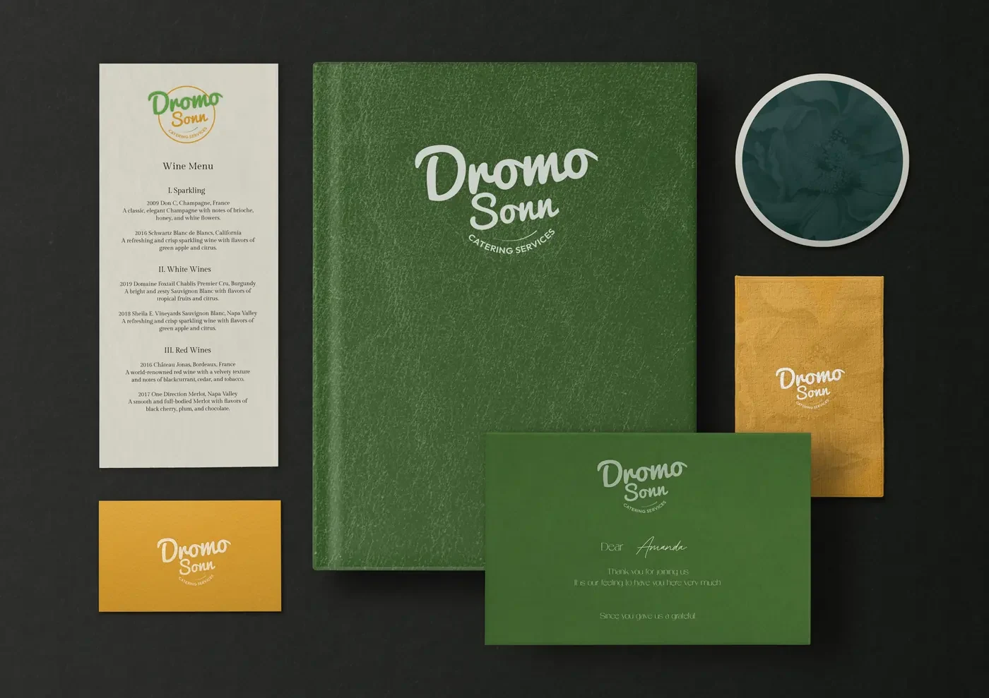 Dromo Sonn wine menu, hardcover book, coaster, gold envelope and a thank-you card reading Dear Amanda