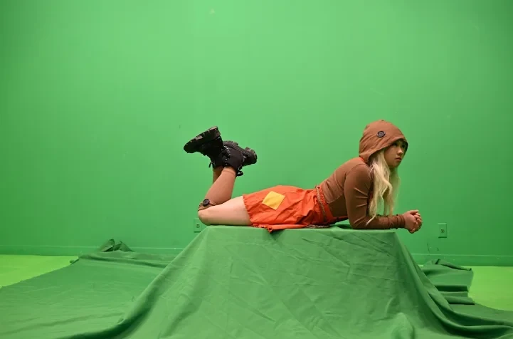 The actor lying on a green-draped platform to be composited as if flying